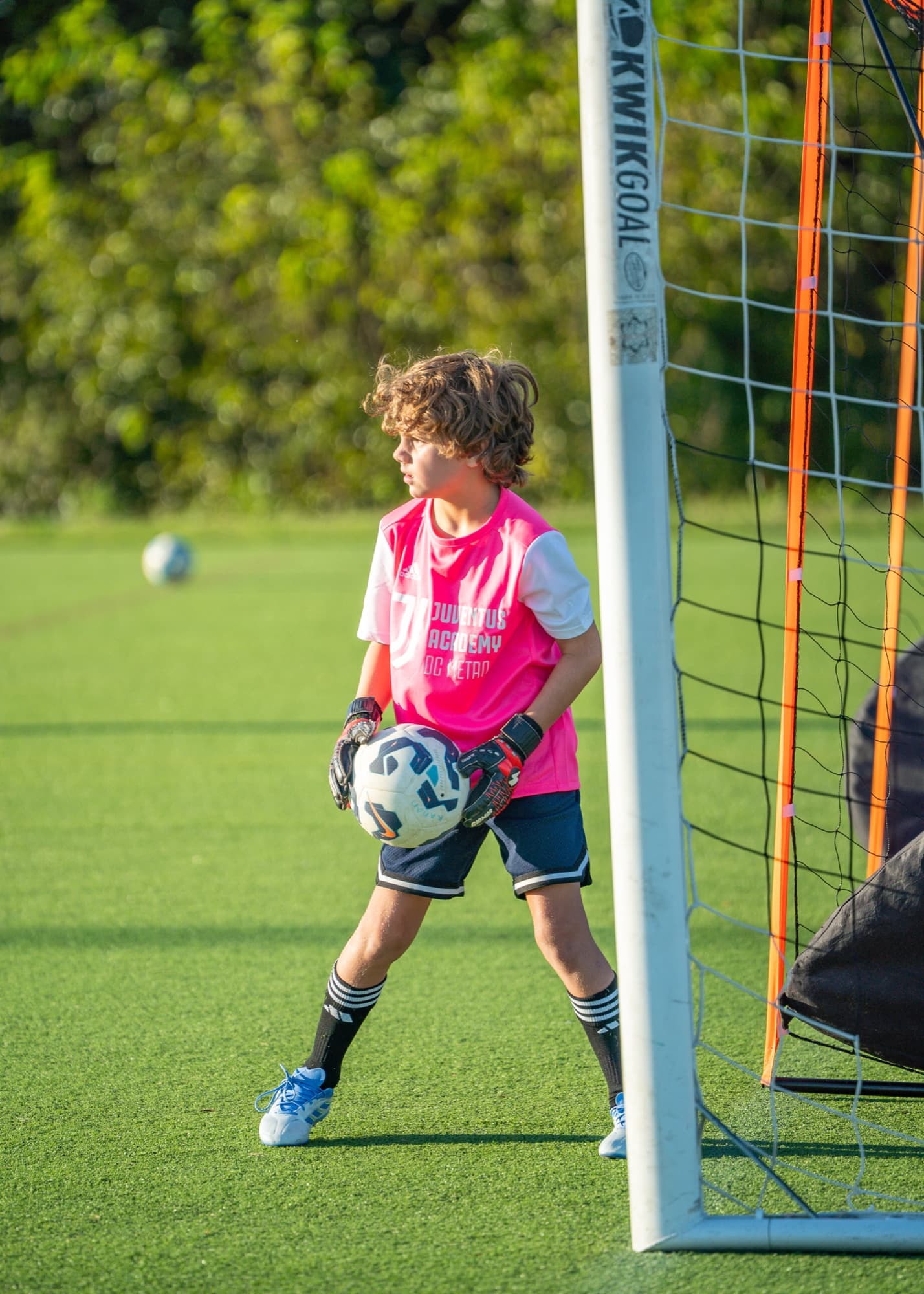 Goalkeeper holding the ball by the net