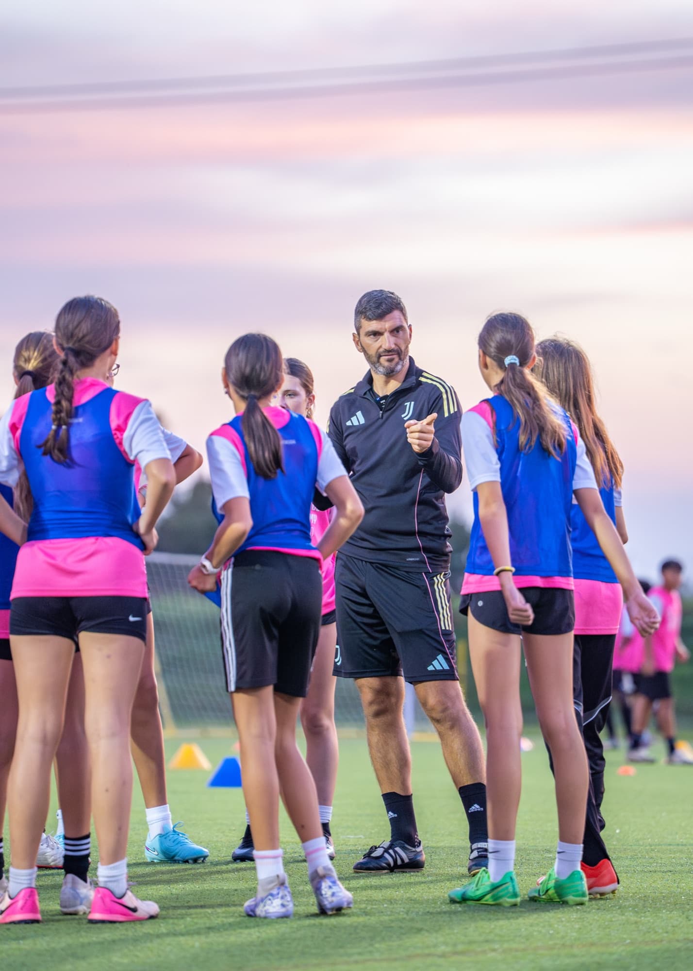 A Juventus coach working with a group of young players